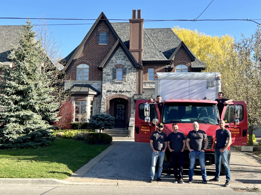 Moving company in Richmond Hill with moving truck and movers in front of house.